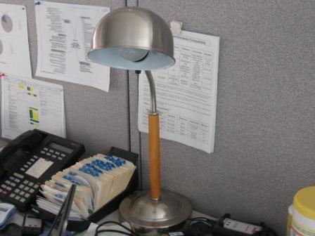 Metal cubicle lamp on desktop
