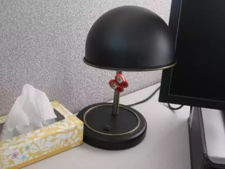 Metal desk lamp in cubicle