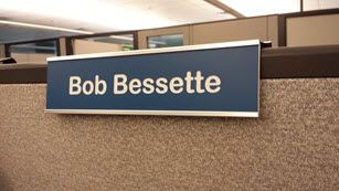 My nameplate proudly displayed on my cubicle wall.