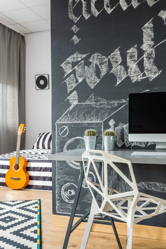 chalkboard feature wall in an office bedroom combo