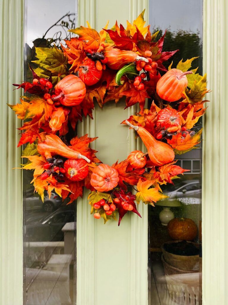 a wreath is hanging on a front door