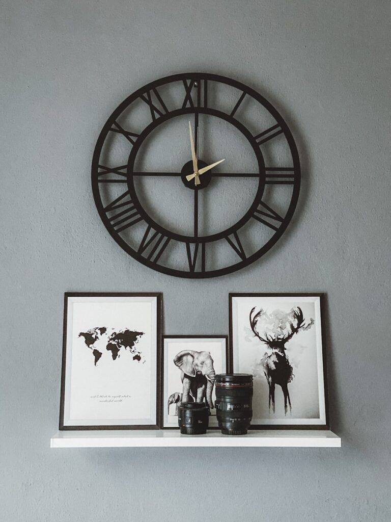 gold and black round analog wall clock