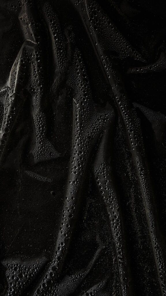 a black cloth with water drops on it