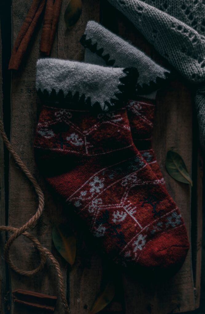 a pair of red socks sitting on top of a wooden table