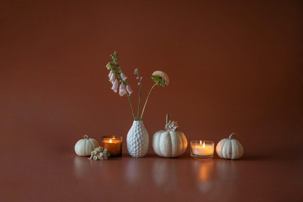 a group of vases with flowers and candles on a table