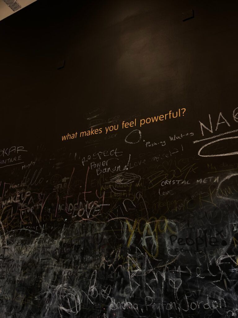 A wall covered in graffiti and writing on it