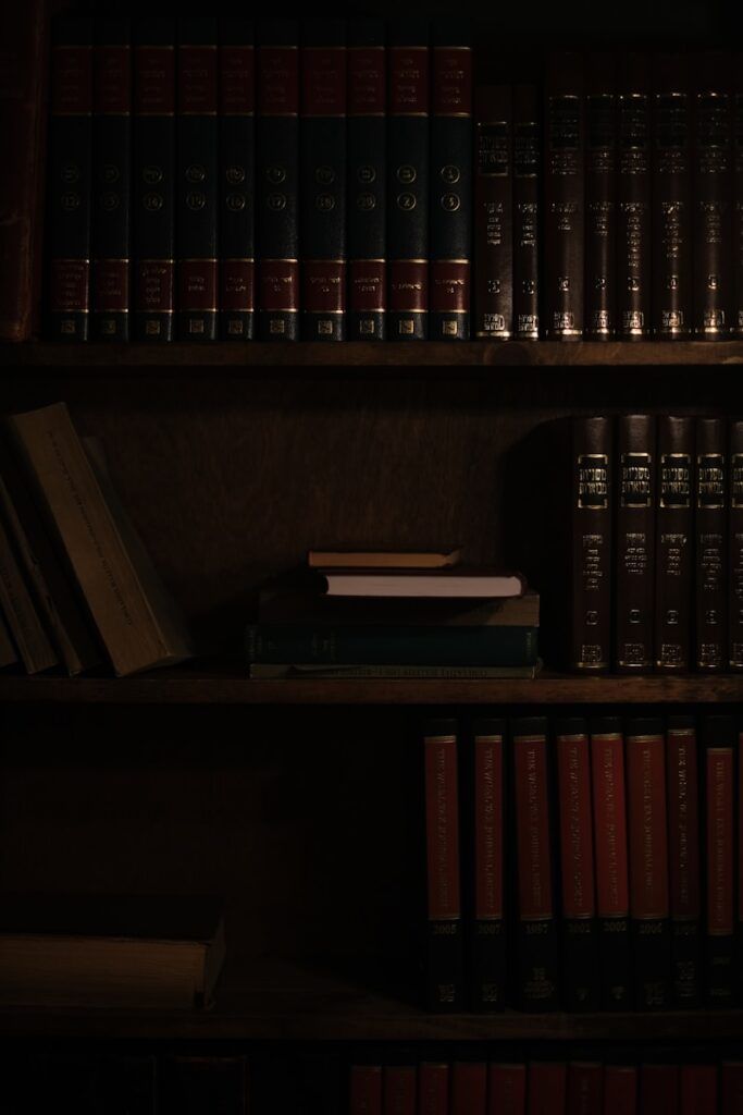a bookshelf filled with lots of books in a dark room