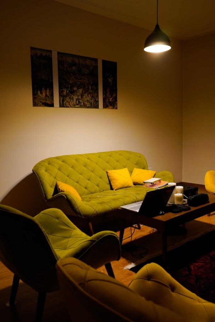 A cozy living room with green furniture.