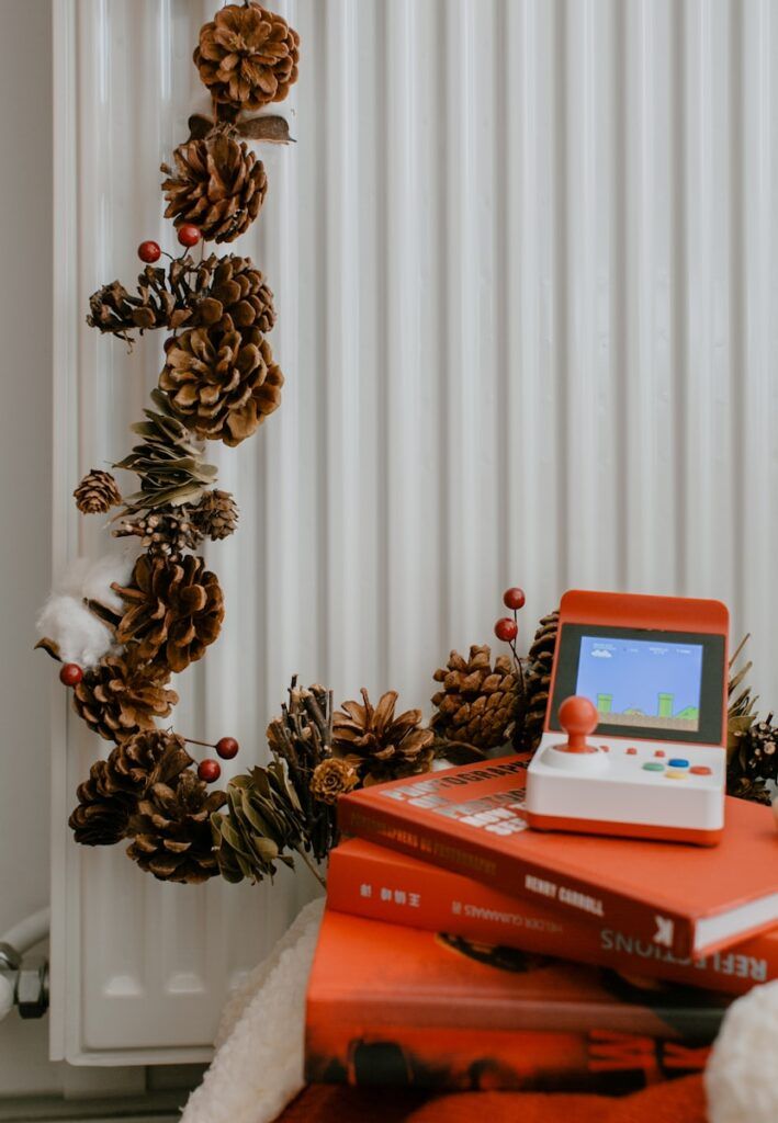 a stack of books sitting next to a christmas tree
