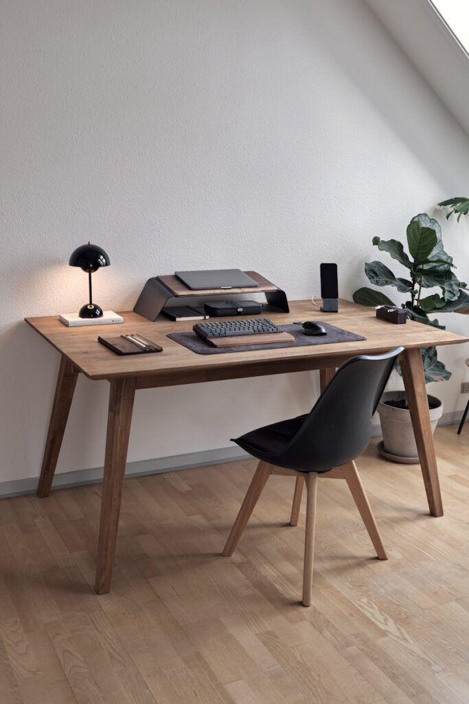a teak desk with a computer and a chair