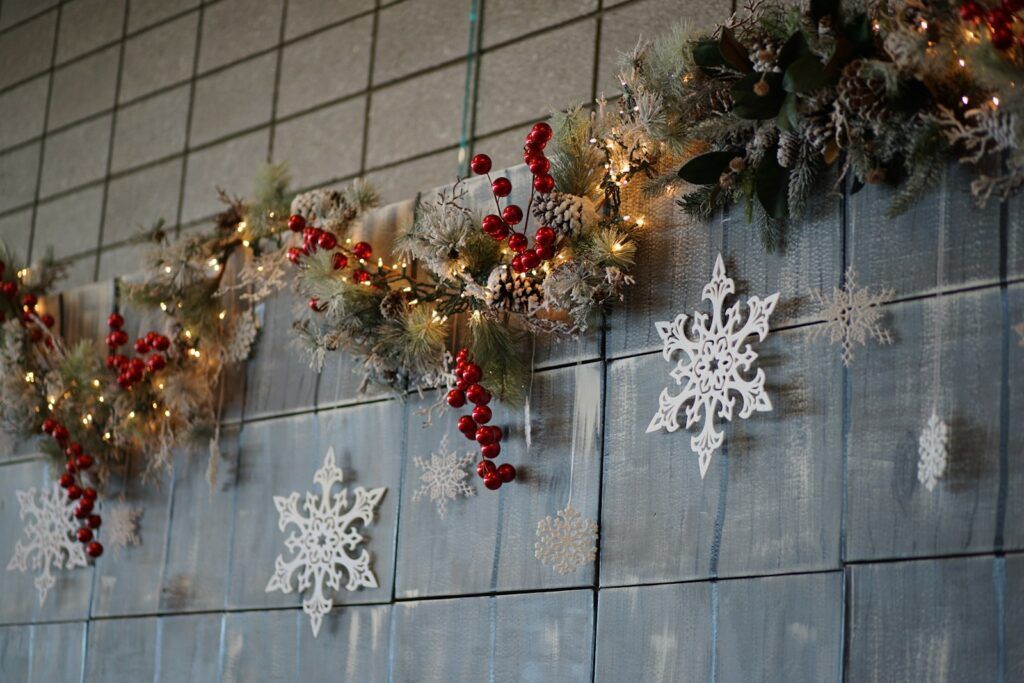 silver snowflakes, red baubles, and Christmas decorations on wall