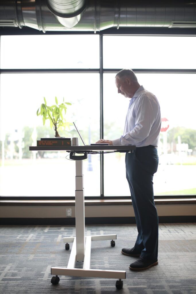 A man using a Standing Desk Setup 