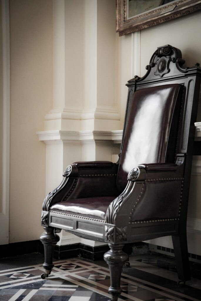 a chair sitting in a room next to a wall