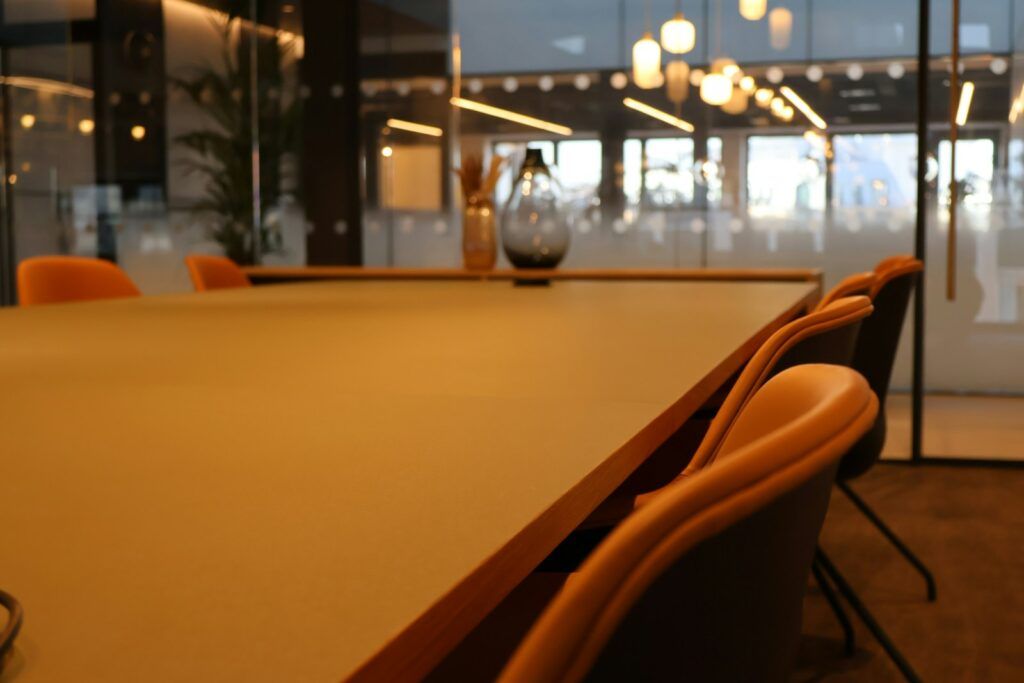 A conference room with a large table and chairs