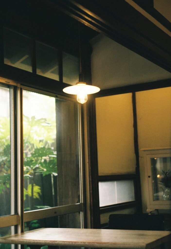 a table sitting in front of a window in a room