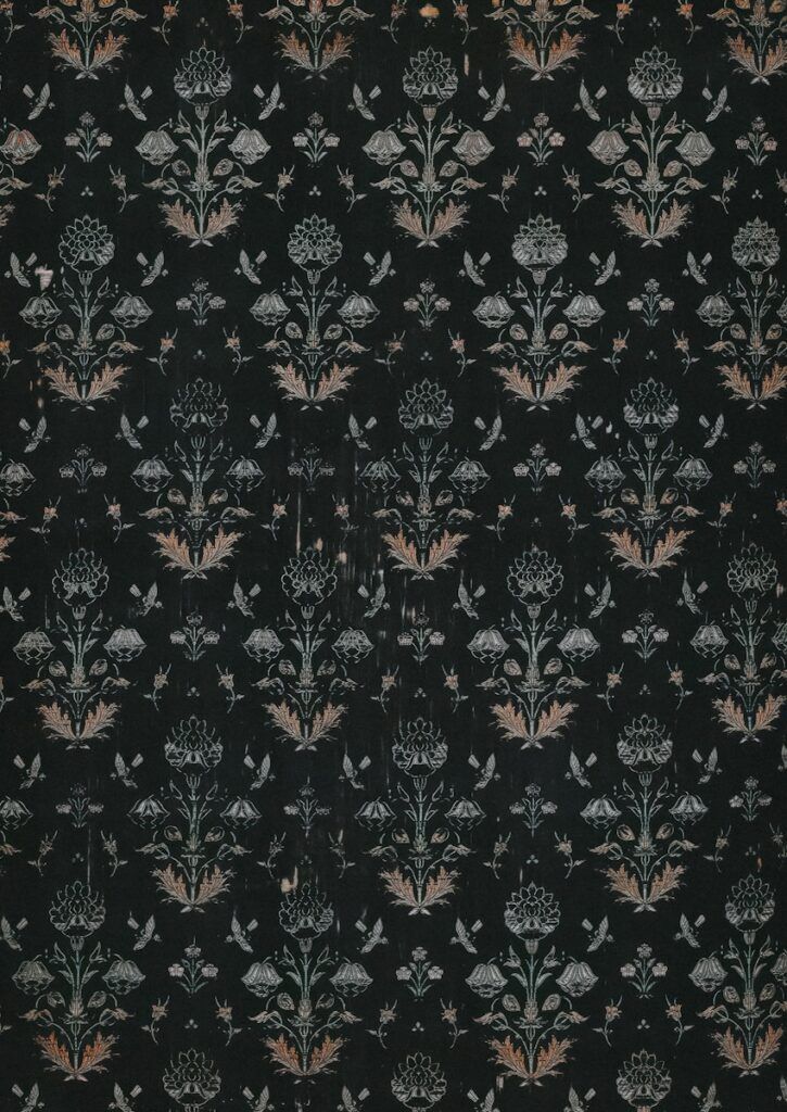 a black wallpaper with a floral design on it