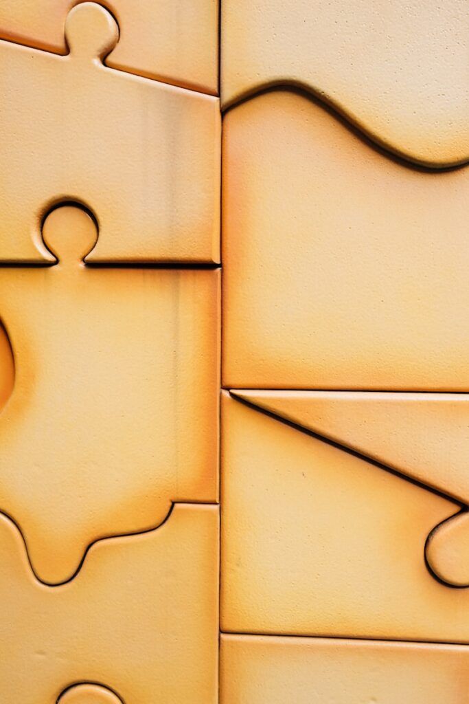 Close-up of interlocking puzzle pieces with warm lighting.