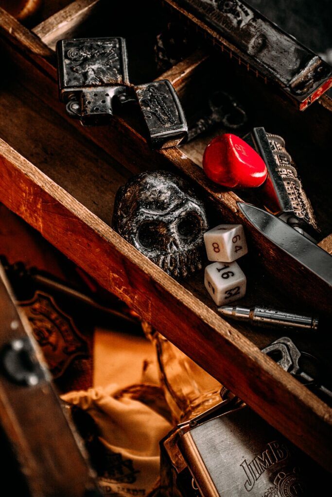 a wooden box filled with dice and other items