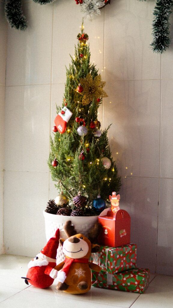 a small christmas tree with presents under it