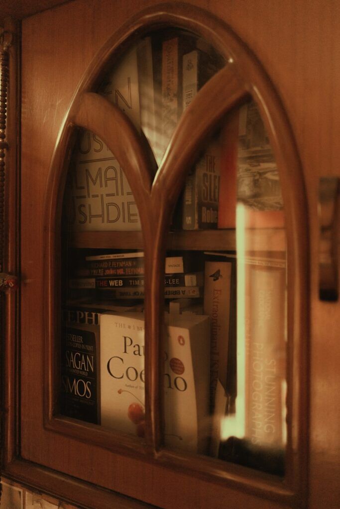 a book shelf with books and a mirror