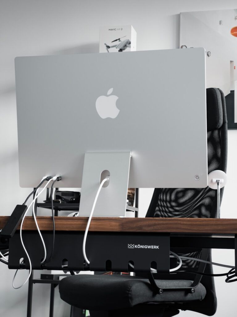 a computer monitor sitting on top of a wooden desk