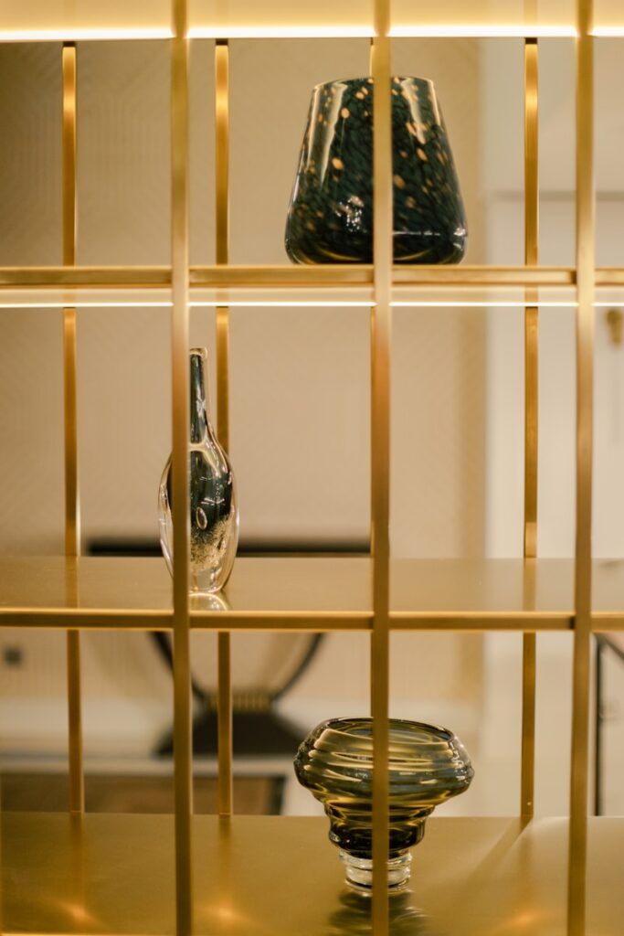 a glass vase and a glass vase on a shelf