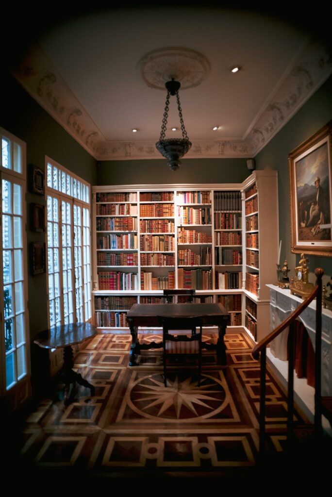 a room filled with lots of books and a table