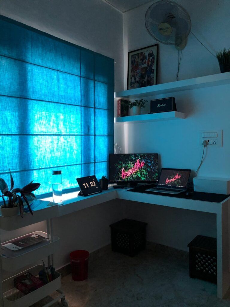 black laptop computer on white wooden desk