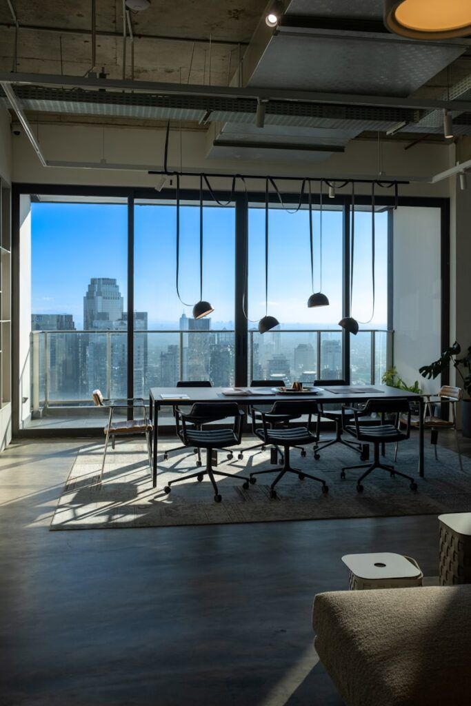 a room with a table and chairs and a view of the city