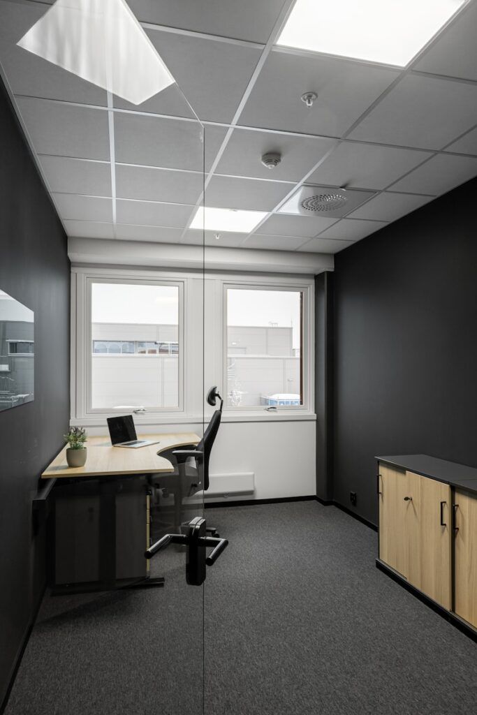 An empty office with black walls and a white ceiling