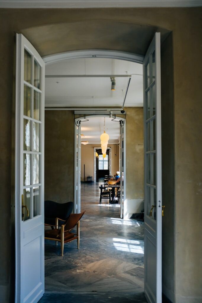 a hallway with a table and chairs