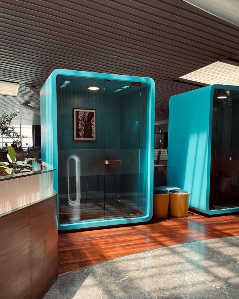 a retro futuristic office cubicle with a blue wall and a wooden floor