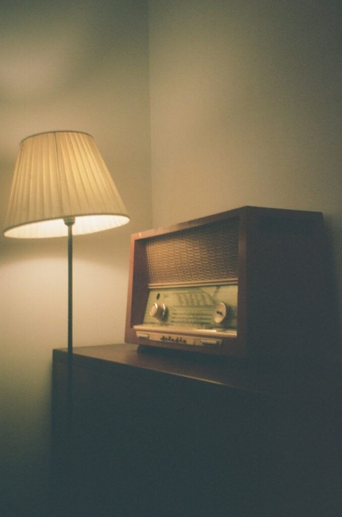 a lamp next to a wooden cabinet