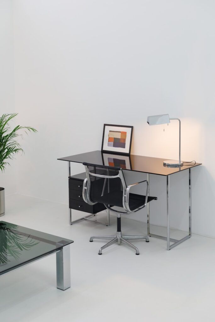 A desk with a chair and a computer on it