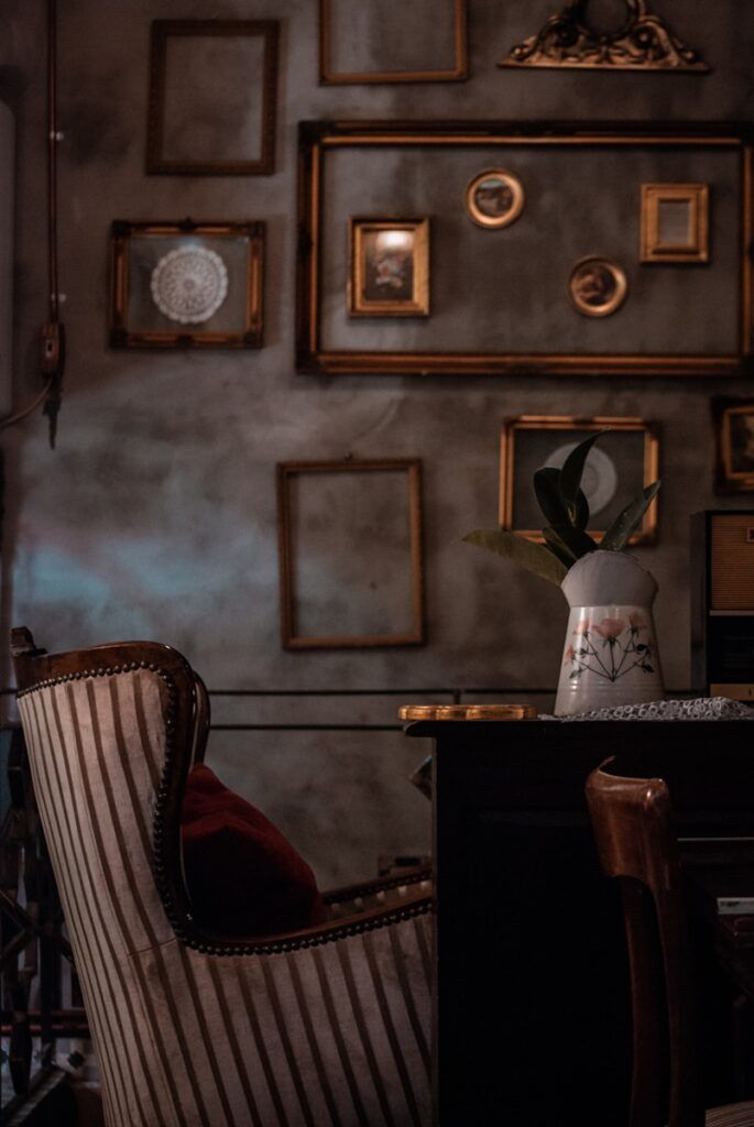 white and red floral vase on brown wooden table