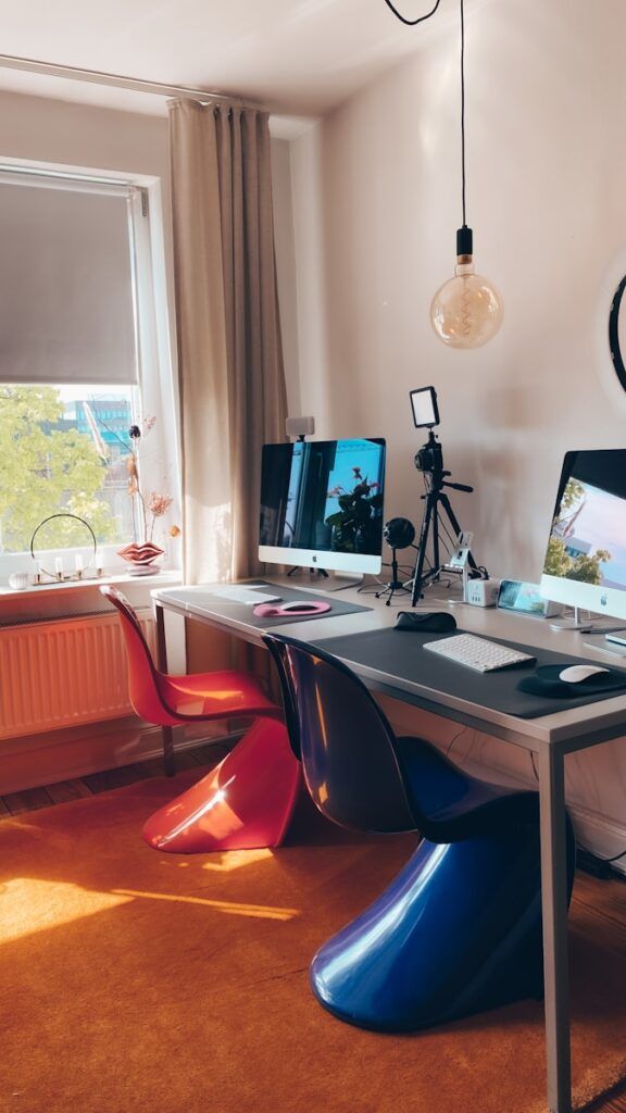 black flat screen computer monitor on white wooden desk