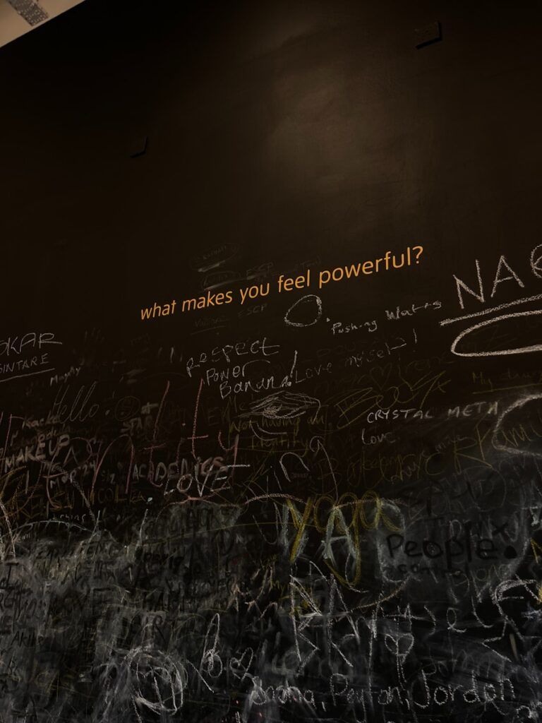 A wall covered in graffiti and writing on it