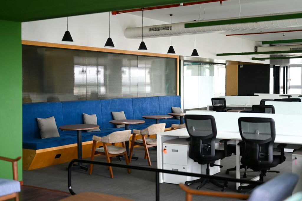 Modern office space with blue seating and desks