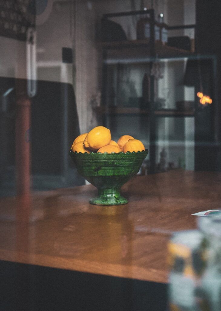 lemons in green ceramic bowl