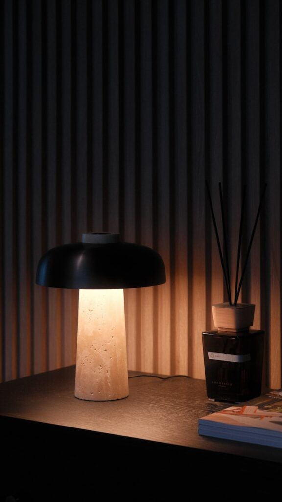 A table with a lamp and a book on it