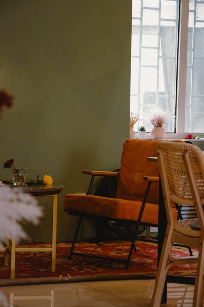 a room with a table, chairs and a rug