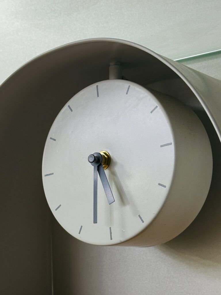 A clock on a wall with a glass top