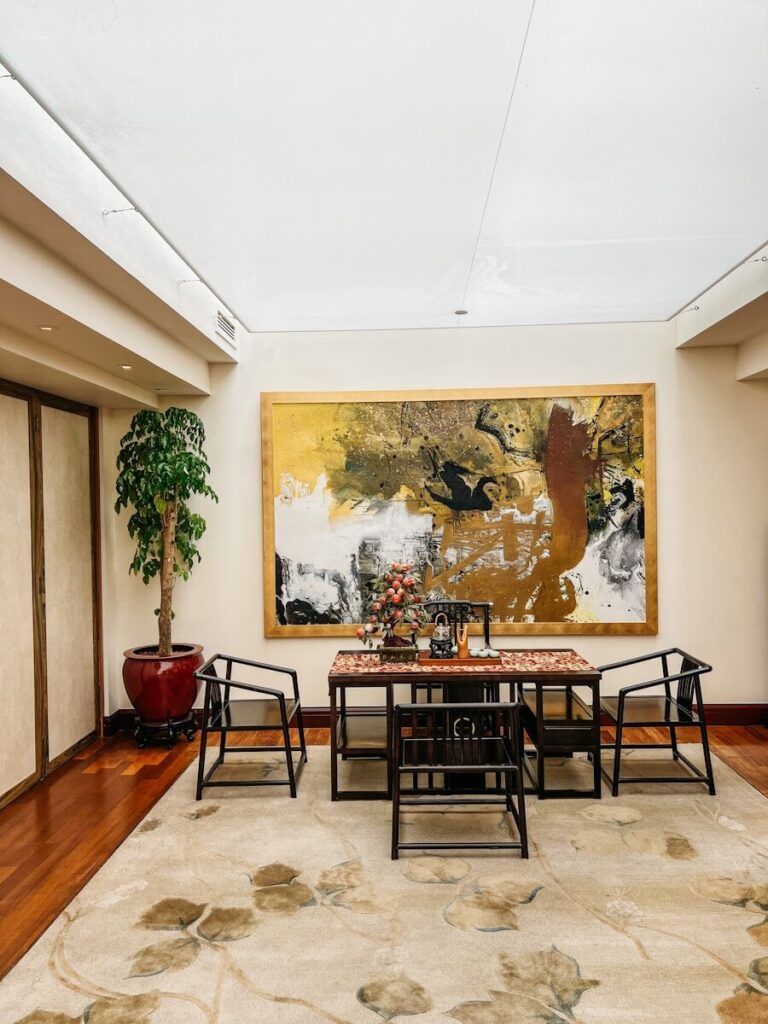 a room with a table and chairs and a map on the wall