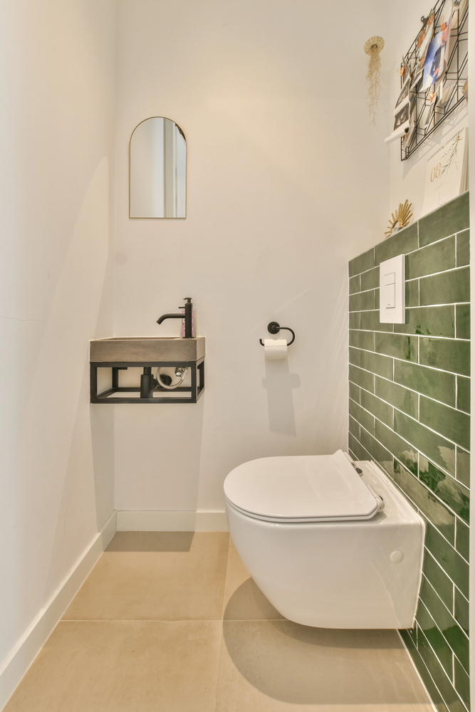 glossy green subway tile in a narrow bathroom