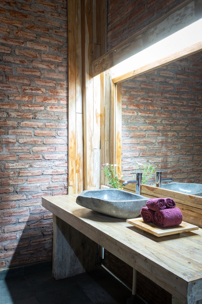 Rustic Vanity Framed by Exposed Brick