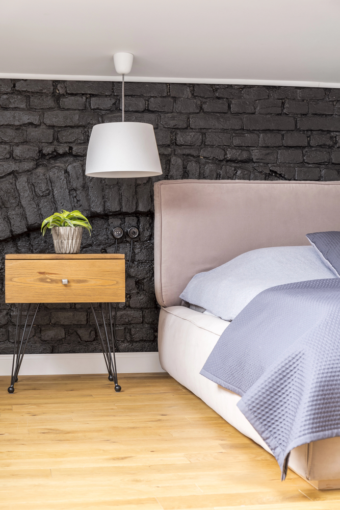 black brick accent wall in a bedroom