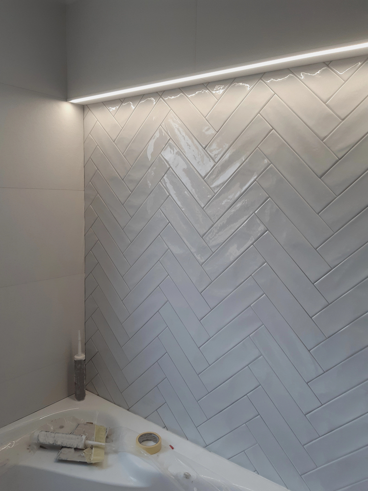 Herringbone Tile Accent Wall in a bathroom