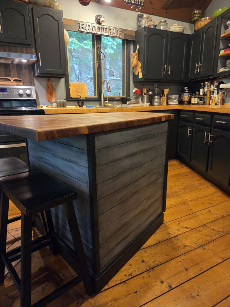 Dark Rustic Kitchen With a Warm Wood Island