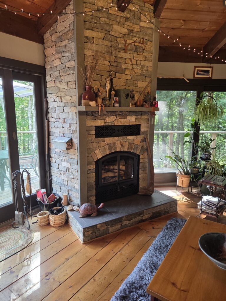 rustic home with a stone fireplace