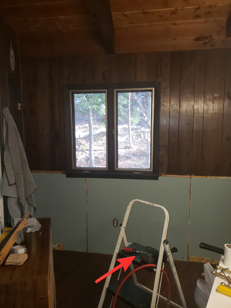 The bathroom wall and brad nailer set up and ready before installing the wood accent wall